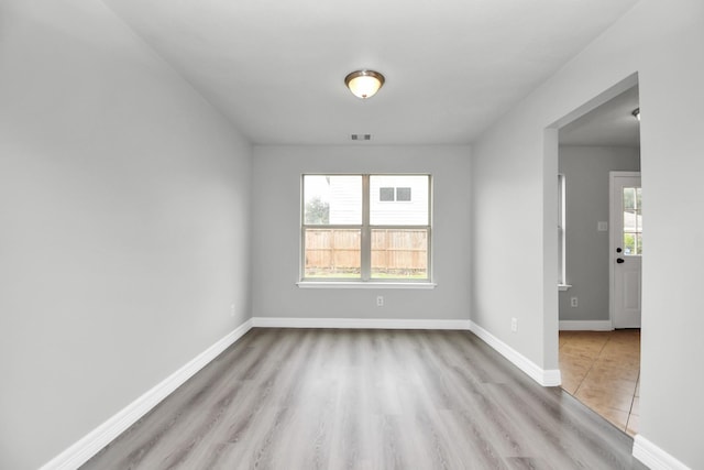 spare room featuring light hardwood / wood-style floors