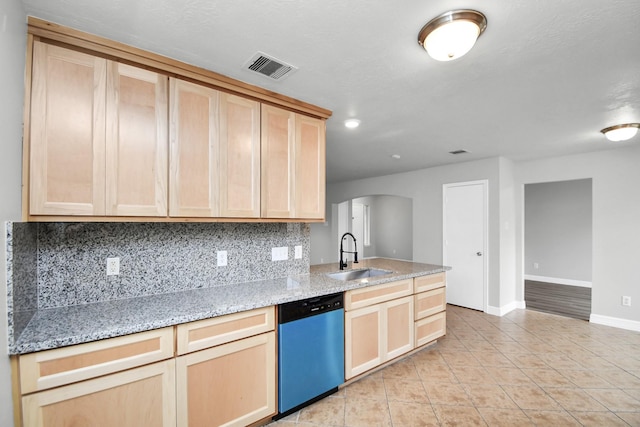 kitchen featuring dishwasher, light brown cabinets, light stone countertops, and sink