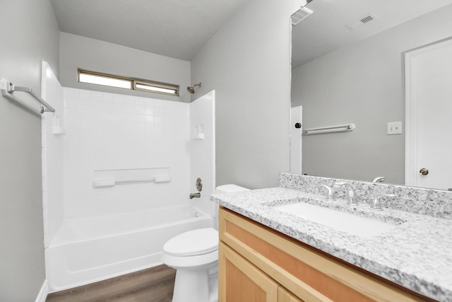 full bathroom with vanity, wood-type flooring, tub / shower combination, and toilet