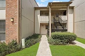 view of exterior entry with a yard