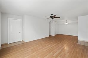 spare room featuring hardwood / wood-style flooring and ceiling fan