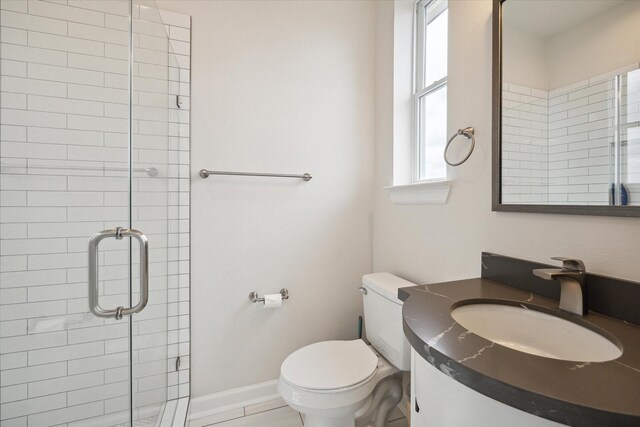 bathroom featuring vanity, toilet, and walk in shower