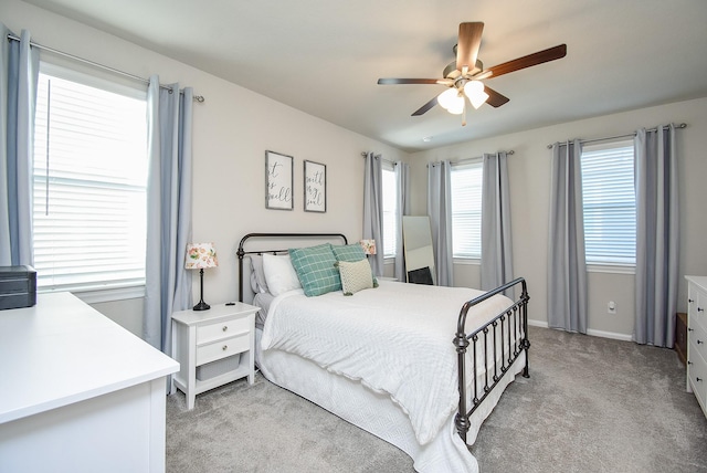 bedroom featuring ceiling fan and light carpet