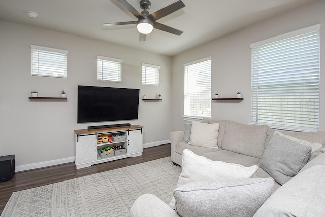 living room with dark hardwood / wood-style floors and ceiling fan