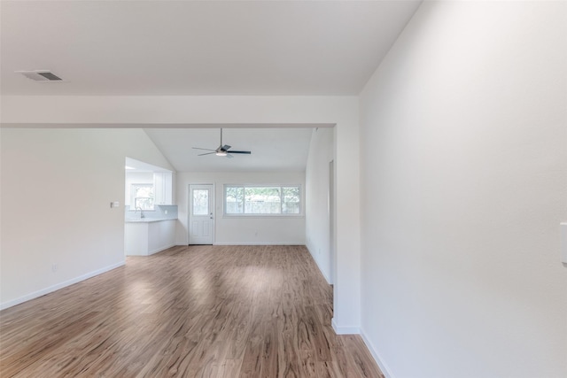 spare room with ceiling fan, hardwood / wood-style floors, vaulted ceiling, and sink