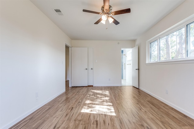 unfurnished bedroom with ceiling fan, light hardwood / wood-style floors, and multiple windows