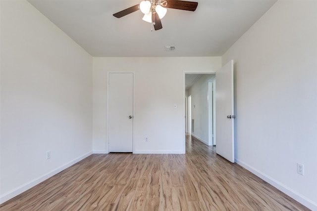 spare room featuring ceiling fan and light hardwood / wood-style flooring