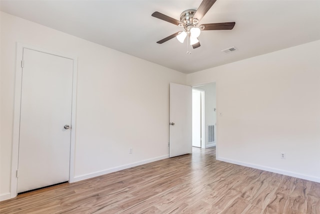 empty room with light wood-type flooring and ceiling fan