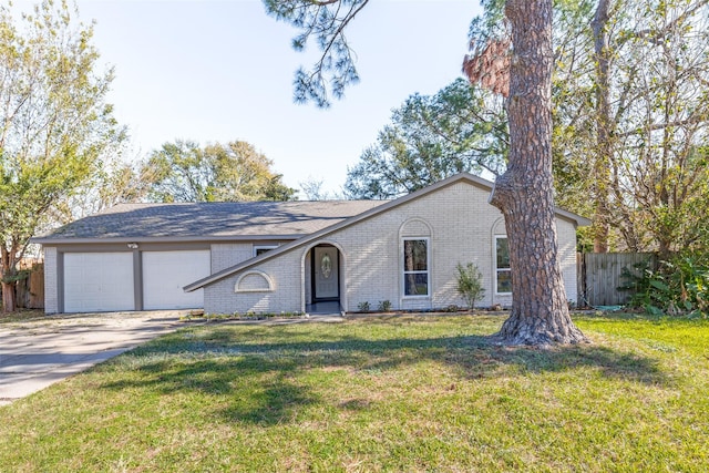 ranch-style house featuring a garage and a front lawn