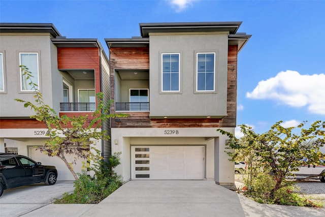 contemporary house with a garage and a balcony