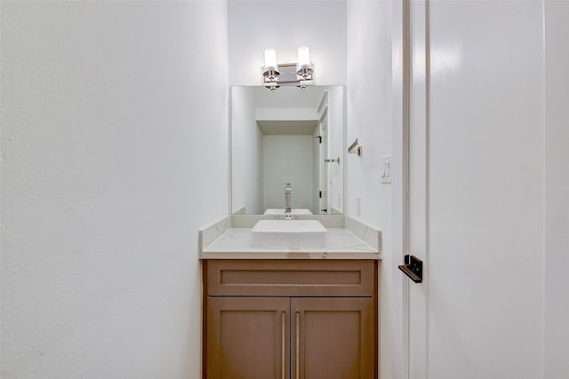 bathroom featuring a notable chandelier and vanity