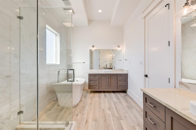 bathroom with vanity, independent shower and bath, and hardwood / wood-style flooring