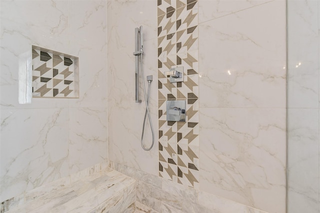 interior details featuring tiled shower