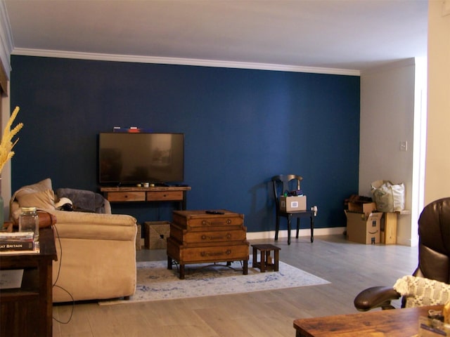 living room with crown molding and hardwood / wood-style floors