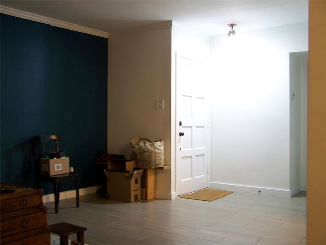 interior space featuring light wood-type flooring and crown molding