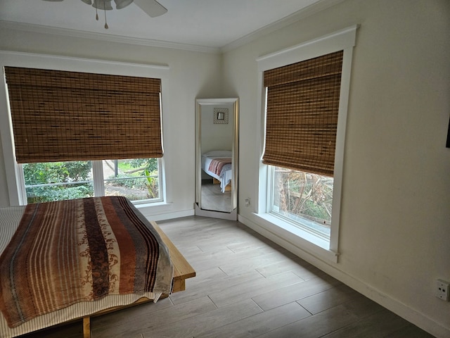 unfurnished bedroom featuring crown molding and light wood-type flooring