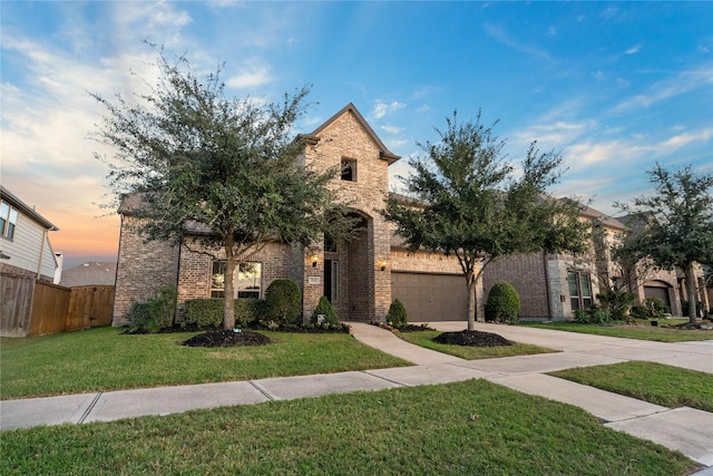 view of front facade with a yard and a garage