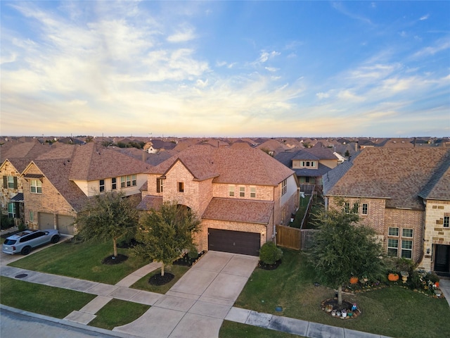 view of front of property with a yard and a garage