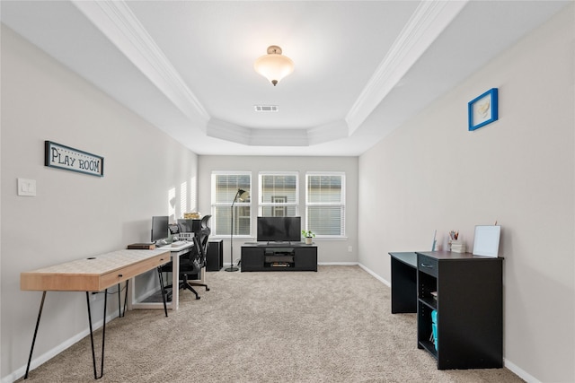 home office with a raised ceiling, carpet floors, and crown molding