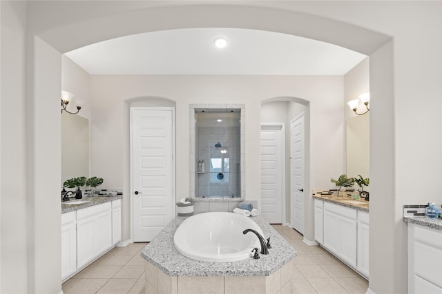 bathroom featuring tile patterned floors, vanity, and independent shower and bath