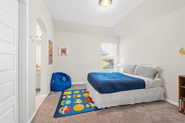 bedroom featuring light colored carpet and lofted ceiling