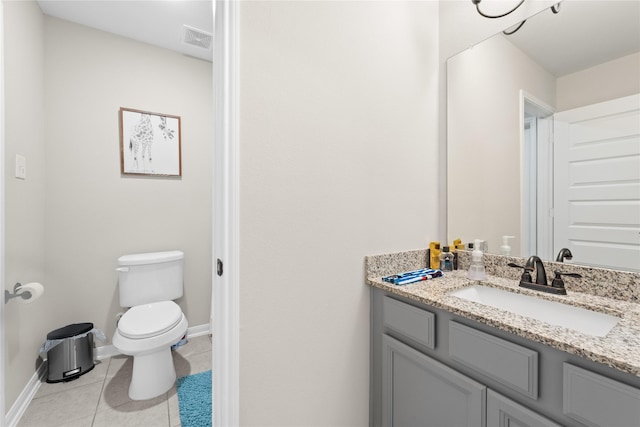 bathroom with tile patterned flooring, vanity, and toilet