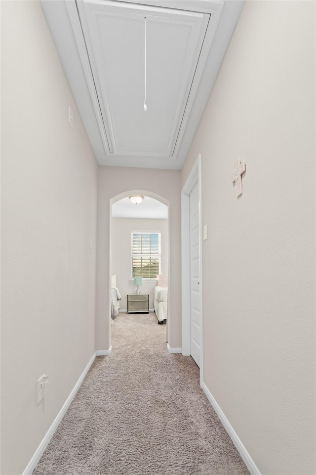 hallway featuring light colored carpet