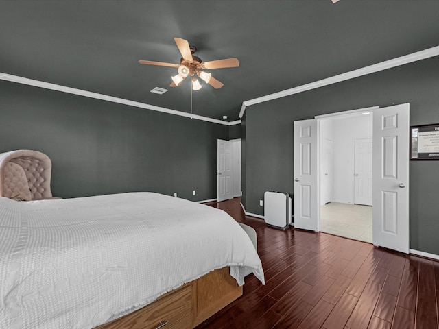 bedroom with ceiling fan, dark hardwood / wood-style flooring, and crown molding