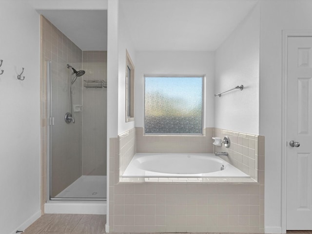 bathroom featuring tile patterned floors and shower with separate bathtub