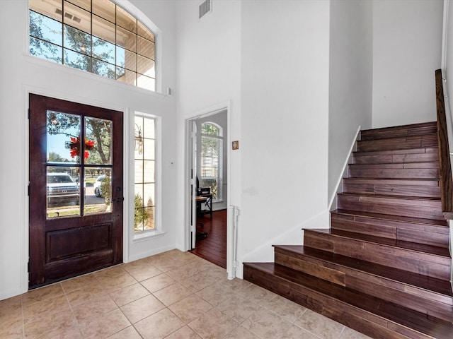 entrance foyer with light wood-type flooring and a high ceiling