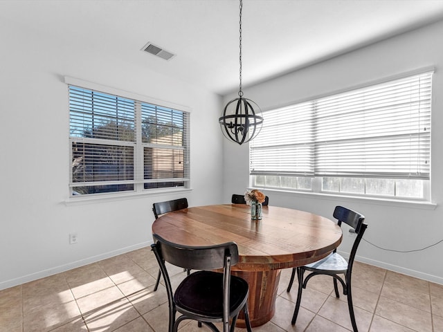 tiled dining space with a notable chandelier