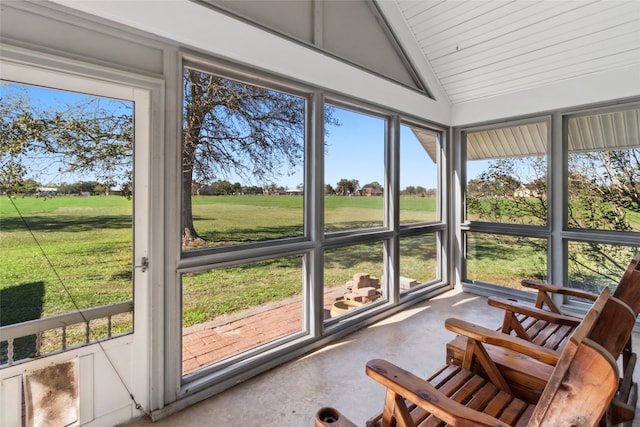 sunroom / solarium with a healthy amount of sunlight and lofted ceiling