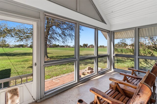 sunroom / solarium with a healthy amount of sunlight and lofted ceiling