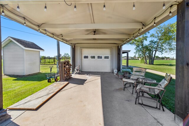 view of patio featuring a garage and a storage unit