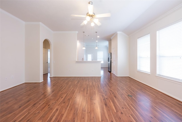 unfurnished living room with dark hardwood / wood-style floors, ceiling fan, and crown molding