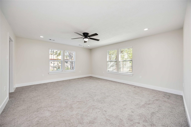 unfurnished room with ceiling fan and light carpet