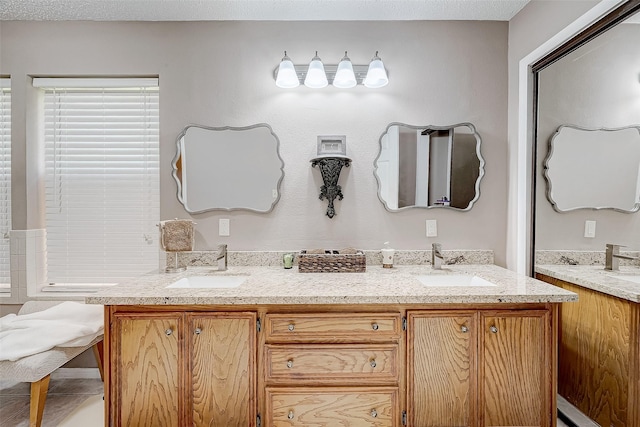 bathroom with vanity and a textured ceiling