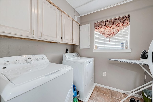 washroom with light tile patterned floors, cabinets, separate washer and dryer, and electric panel