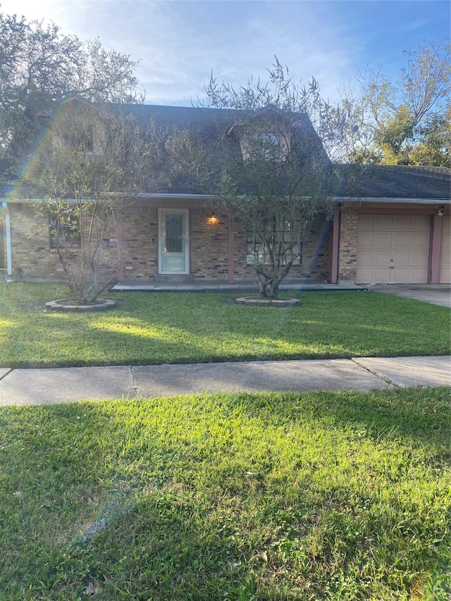 single story home with a front yard and a garage