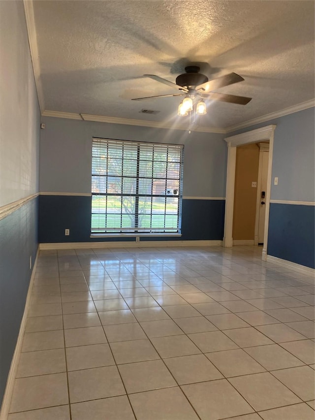 unfurnished room with ceiling fan, ornamental molding, and a textured ceiling