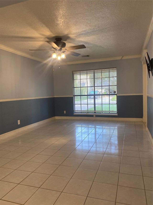 tiled spare room with a textured ceiling, ceiling fan, and crown molding