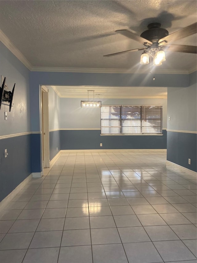 unfurnished room featuring ceiling fan, crown molding, and a textured ceiling