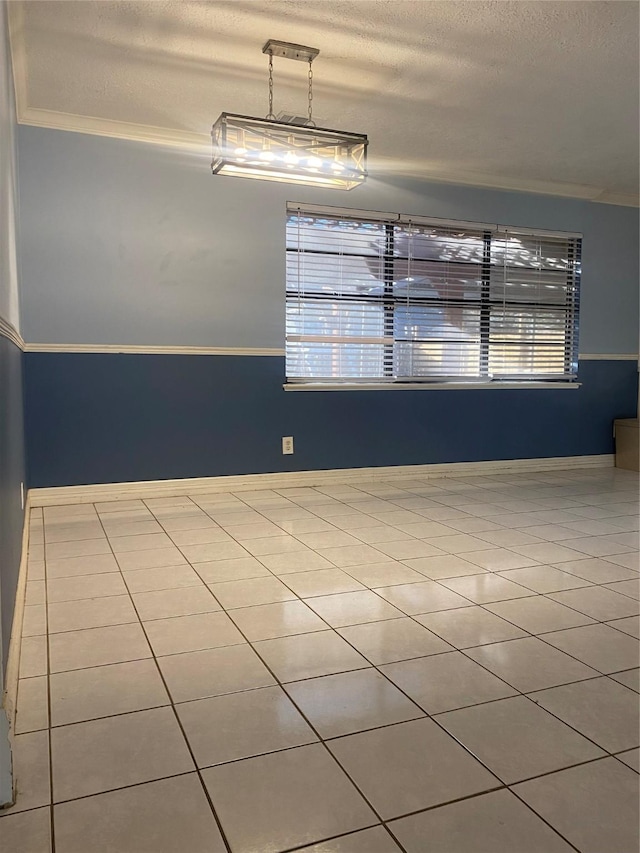 unfurnished dining area featuring a textured ceiling, light tile patterned floors, and crown molding