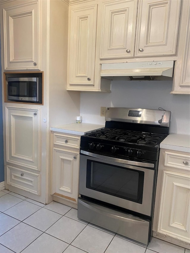 kitchen with light tile patterned floors and stainless steel appliances