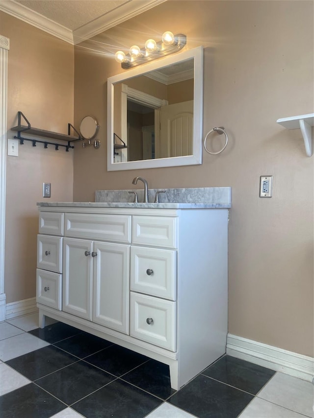 bathroom with crown molding, tile patterned flooring, and vanity