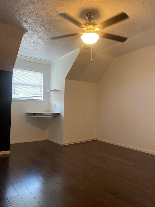 bonus room with ceiling fan, dark hardwood / wood-style flooring, lofted ceiling, and a textured ceiling