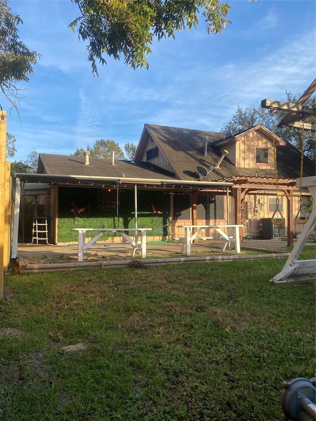 rear view of property with a patio, cooling unit, and a lawn