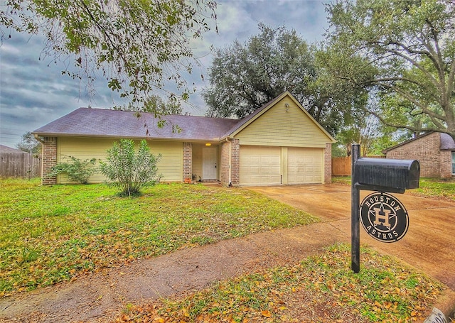 ranch-style house featuring a front lawn and a garage