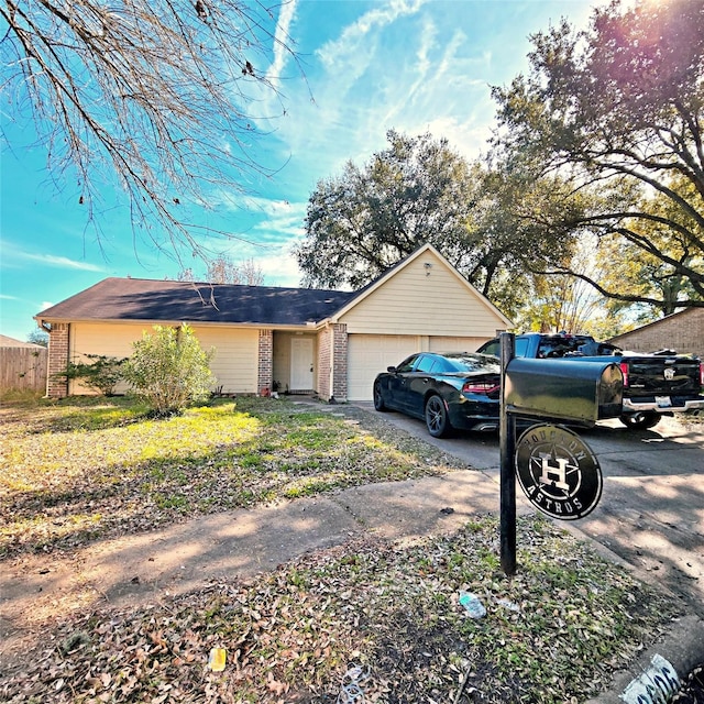 ranch-style home featuring a front yard and a garage