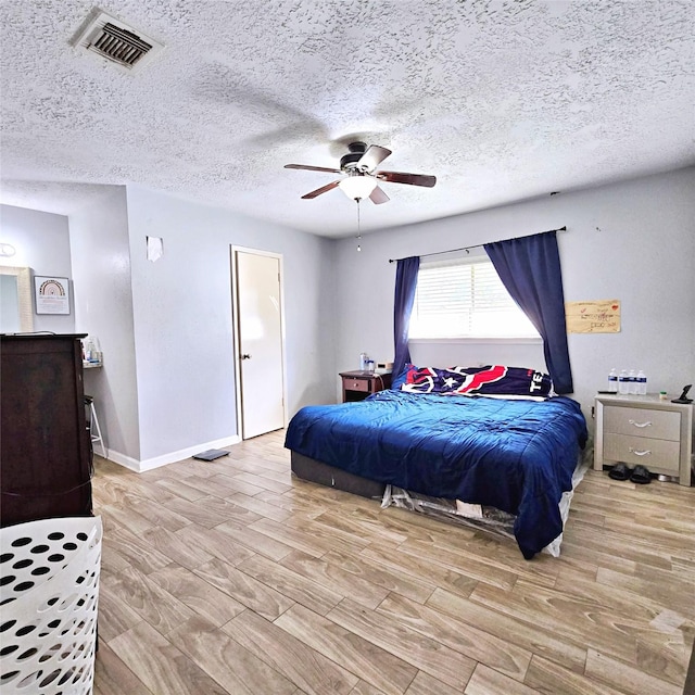 bedroom with ceiling fan and light hardwood / wood-style floors